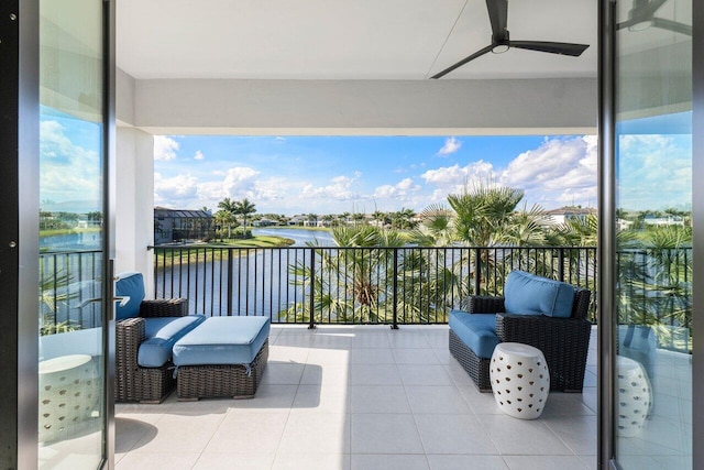 balcony featuring a water view and ceiling fan