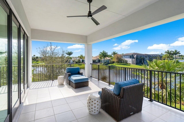 sunroom / solarium with a water view, ceiling fan, and plenty of natural light