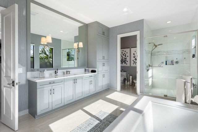 bathroom featuring a bidet, toilet, vanity, and walk in shower