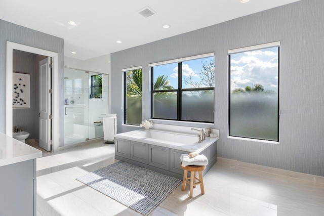 bathroom featuring a bidet, tile patterned flooring, and independent shower and bath