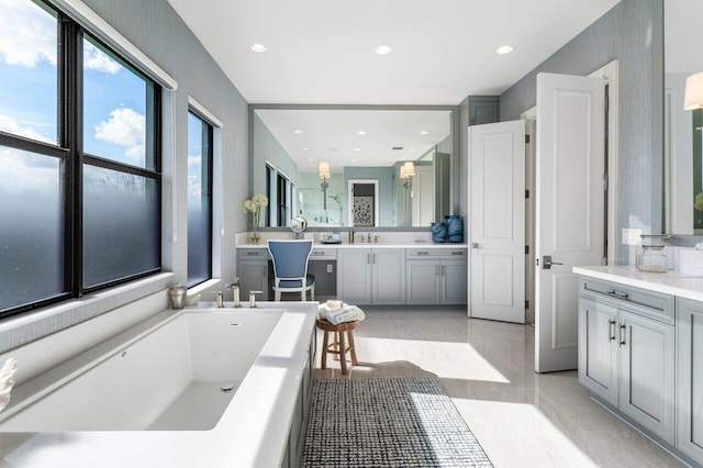 bathroom with vanity and a bath