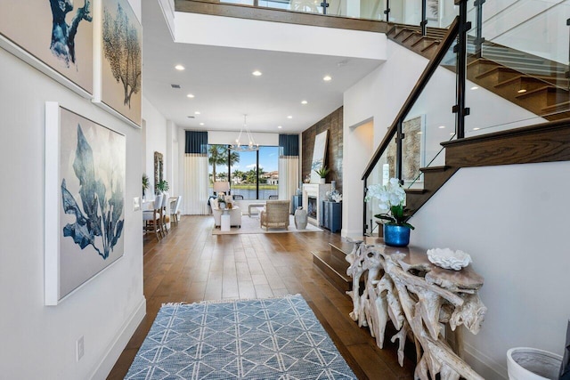 entrance foyer featuring dark wood-type flooring and a chandelier