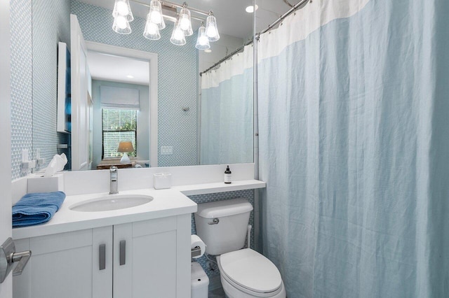 bathroom featuring a shower with curtain, vanity, and toilet