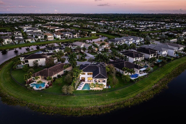 aerial view at dusk with a water view