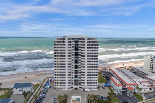 bird's eye view featuring a water view and a view of the beach