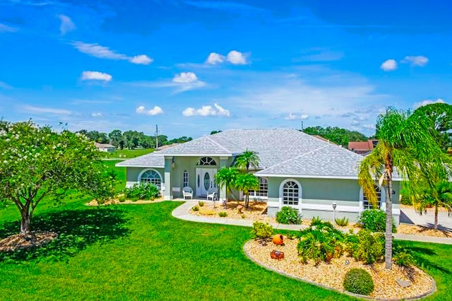 ranch-style home with a front lawn