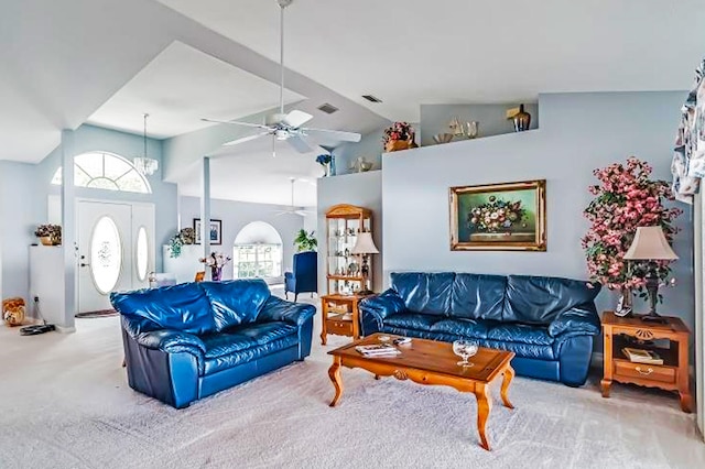 carpeted living room with high vaulted ceiling and ceiling fan