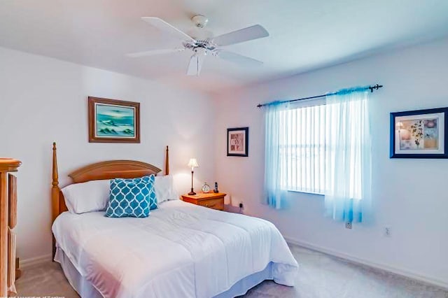 bedroom featuring ceiling fan and light carpet