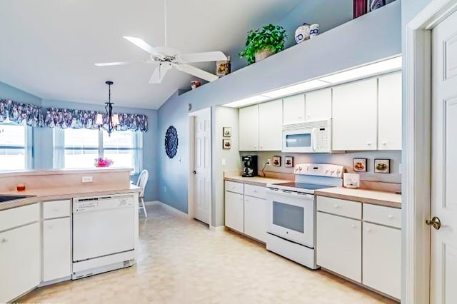 kitchen with pendant lighting, white appliances, lofted ceiling, and white cabinets