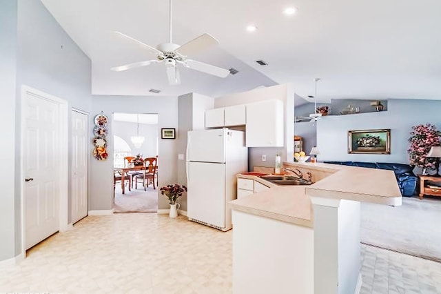 kitchen featuring sink, white cabinetry, white refrigerator, kitchen peninsula, and ceiling fan