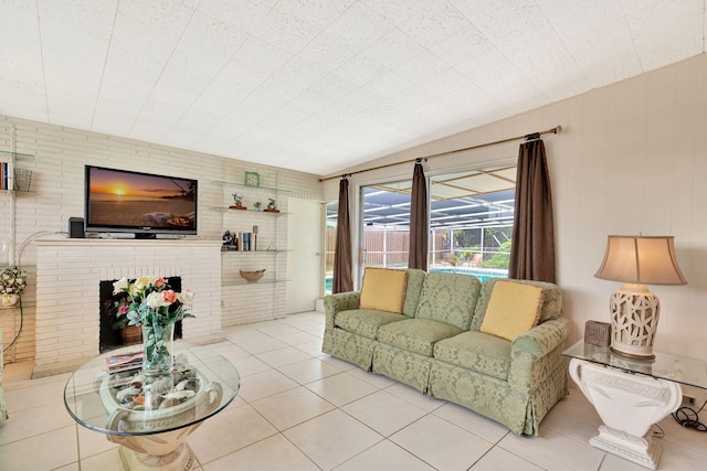 tiled living room featuring a brick fireplace