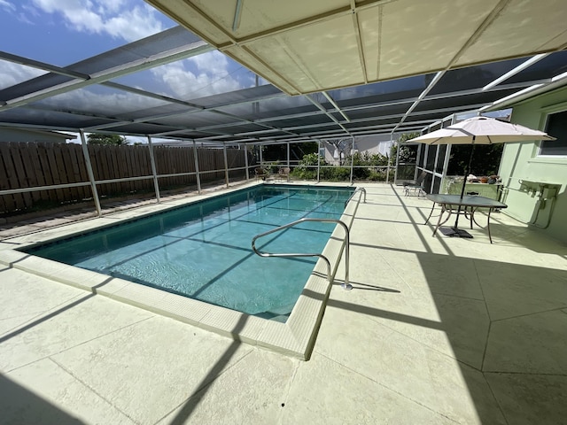 view of pool featuring a patio and glass enclosure