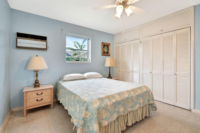 bedroom featuring ceiling fan and two closets