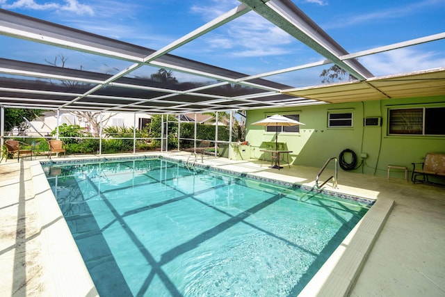 view of swimming pool with a patio area and glass enclosure