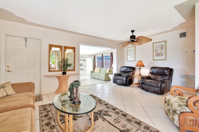 tiled living room featuring ceiling fan