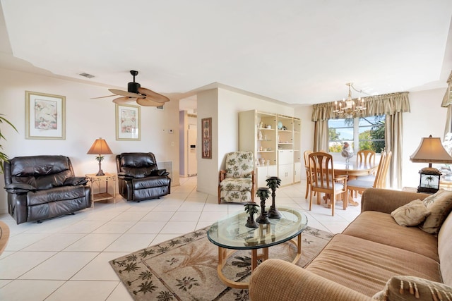 living room with light tile patterned floors and ceiling fan with notable chandelier