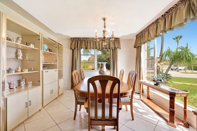 dining space with light tile patterned floors and a chandelier