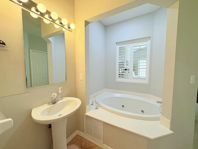 full bath with a whirlpool tub and tile patterned floors