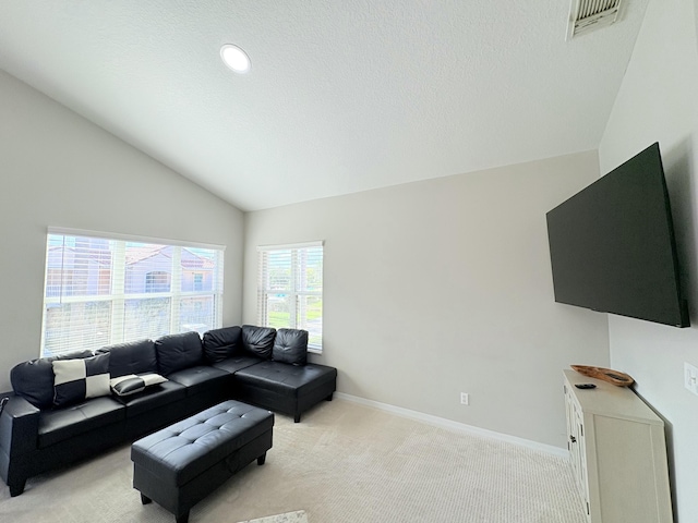 living area with lofted ceiling, visible vents, light carpet, a textured ceiling, and baseboards