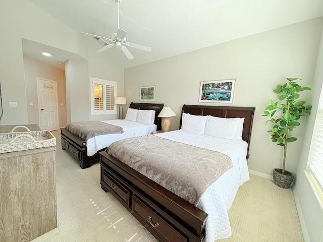bedroom featuring a ceiling fan, light colored carpet, high vaulted ceiling, and baseboards