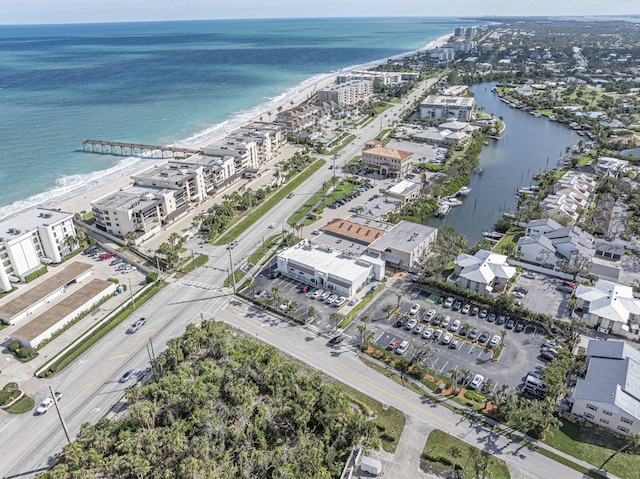 bird's eye view with a water view and a beach view