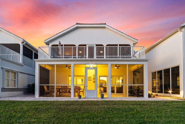 143 Pepper Ln, Jensen Beach, FL 34957 - back of property with a yard, a balcony, stucco siding, and a ceiling fan