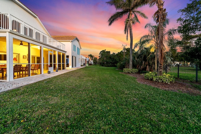 143 Pepper Ln, Jensen Beach, FL 34957 - view of yard featuring a ceiling fan, a patio area, fence, and a balcony