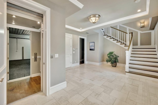 interior space with stairs, recessed lighting, a raised ceiling, and baseboards