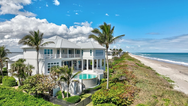 exterior space with fence and a view of the beach