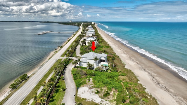 birds eye view of property featuring a water view and a view of the beach