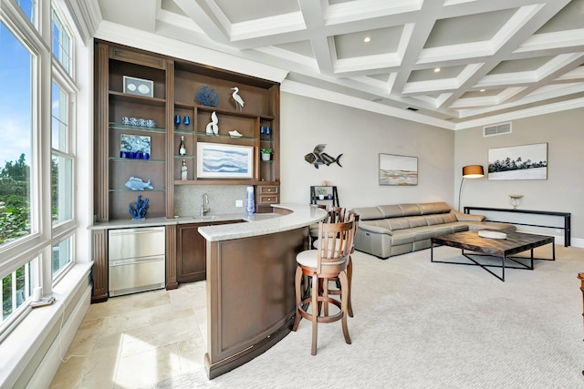 bar with beam ceiling, visible vents, backsplash, ornamental molding, and coffered ceiling