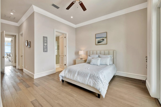 bedroom with ornamental molding, light wood-type flooring, visible vents, and baseboards