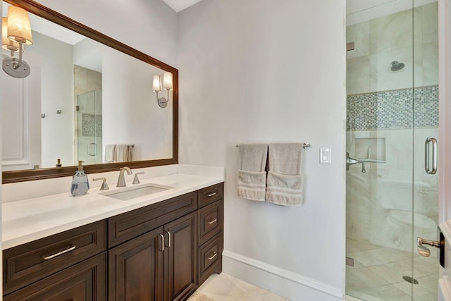 bathroom featuring baseboards, a shower stall, and vanity