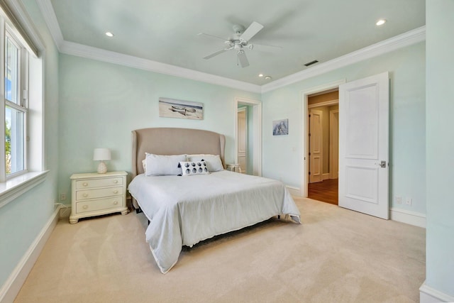 bedroom with ornamental molding, light colored carpet, and baseboards