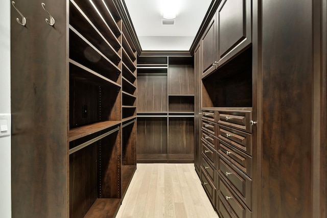 walk in closet with light wood-type flooring and visible vents