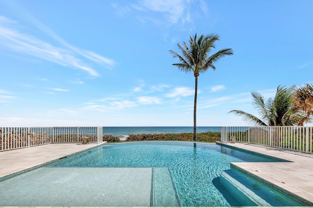 pool featuring a water view, fence, and a patio