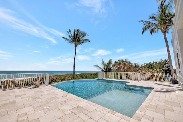 view of swimming pool with a water view, a patio area, and a fenced in pool