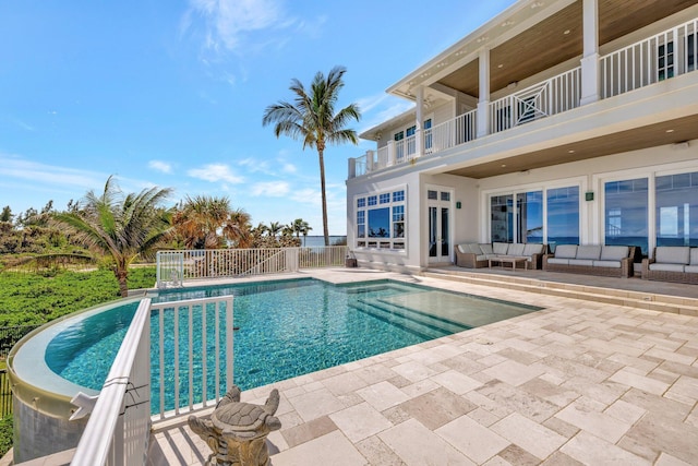 pool featuring french doors, a patio area, fence, and an outdoor living space