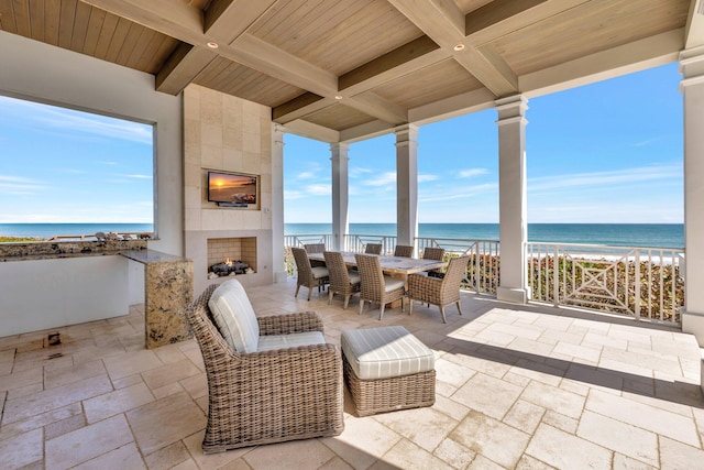 view of patio / terrace featuring outdoor dining space and a large fireplace