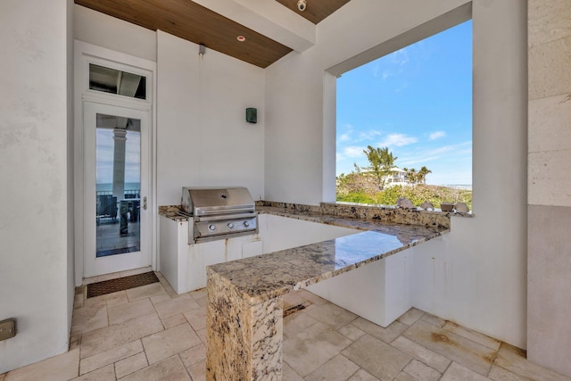 view of patio with an outdoor kitchen and area for grilling