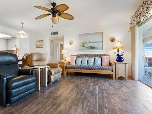 living room with dark wood-type flooring and ceiling fan