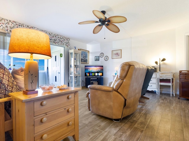 living room featuring wood-type flooring and ceiling fan