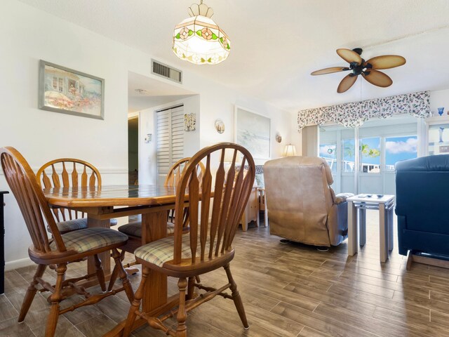 dining area featuring ceiling fan and dark hardwood / wood-style floors