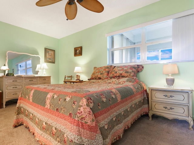 bedroom with ceiling fan and carpet