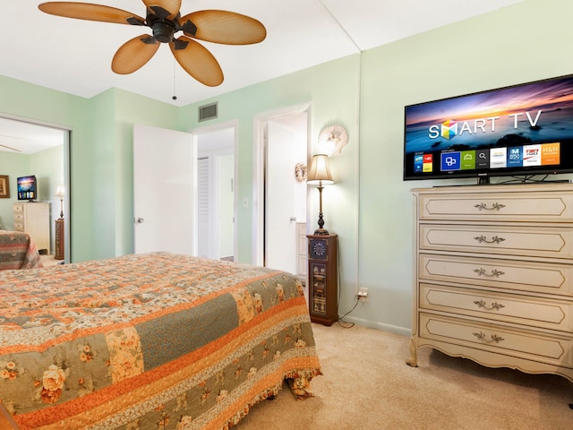 bedroom featuring light colored carpet and ceiling fan