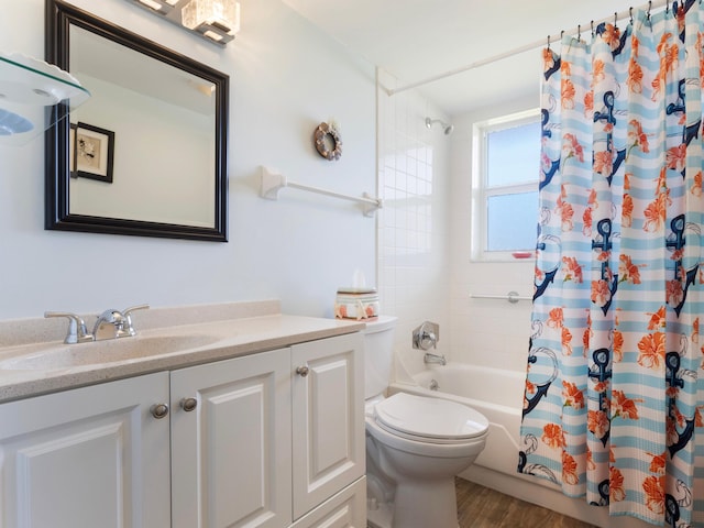 full bathroom with vanity, hardwood / wood-style floors, shower / bath combo, and toilet