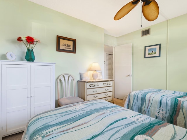 bedroom featuring light carpet and ceiling fan