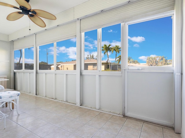 unfurnished sunroom with plenty of natural light and ceiling fan