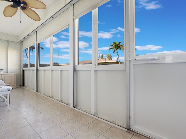 unfurnished sunroom featuring ceiling fan