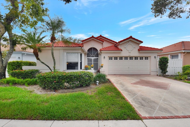 mediterranean / spanish home with a garage